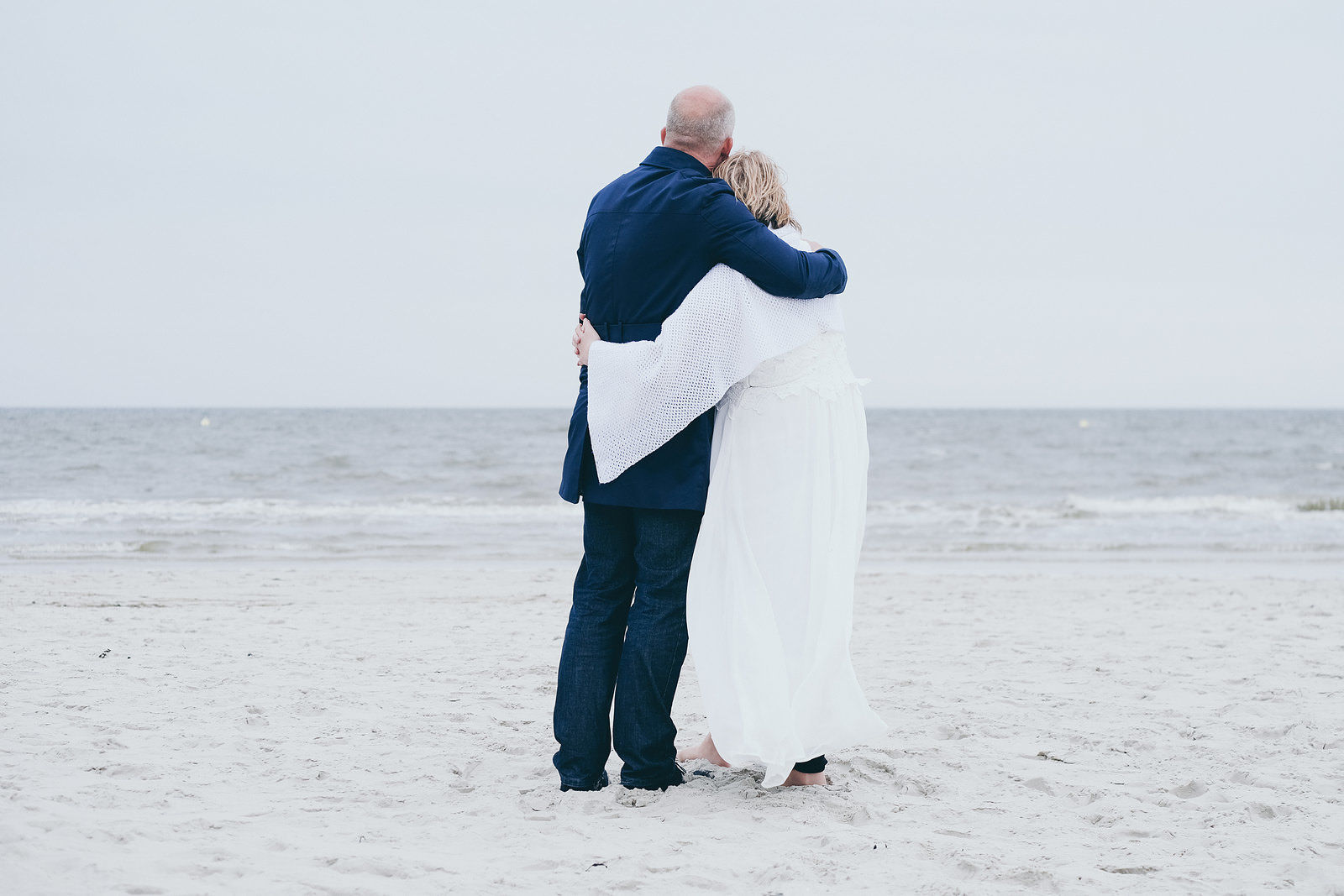Hochzeitsfotograf Brautpaar umarmt sich am Strand in Sankt Peter-Ording